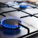 Gas kitchen stove cook with blue flames burning. Panel from steel with a gas